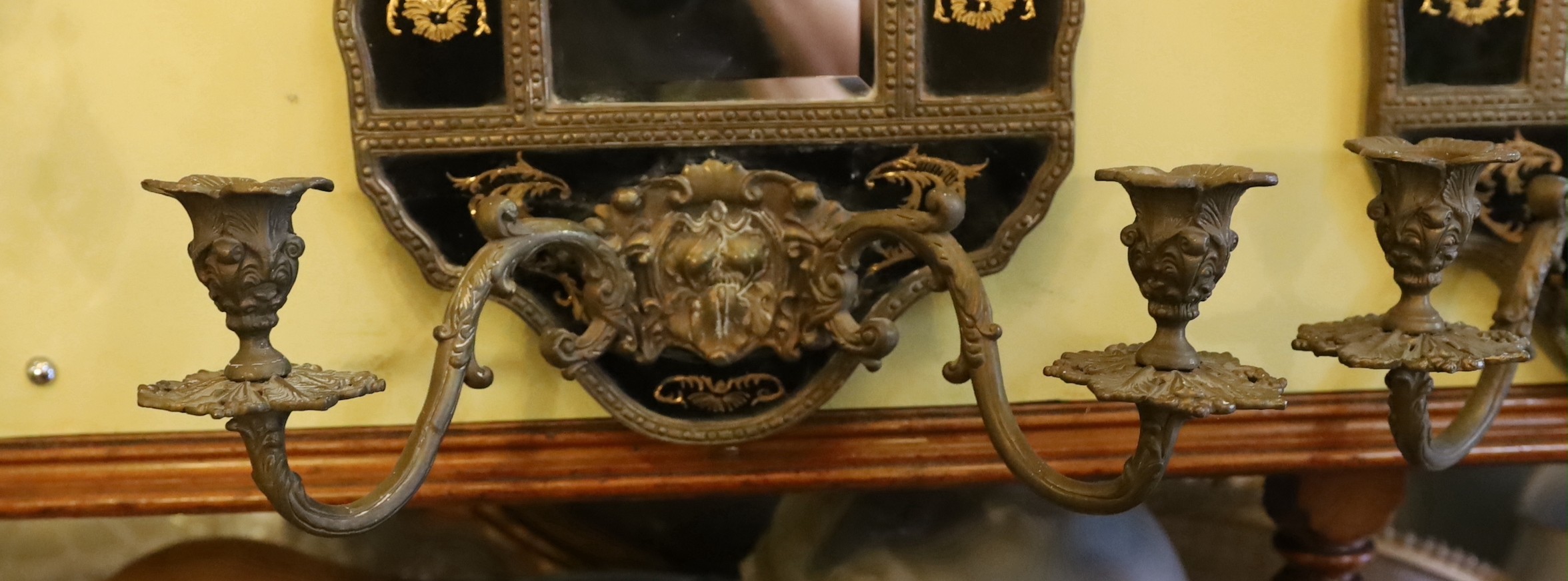 A pair of brass mounted ceramic girandoles in the Louis XIV style, height 64cm. width 38cm